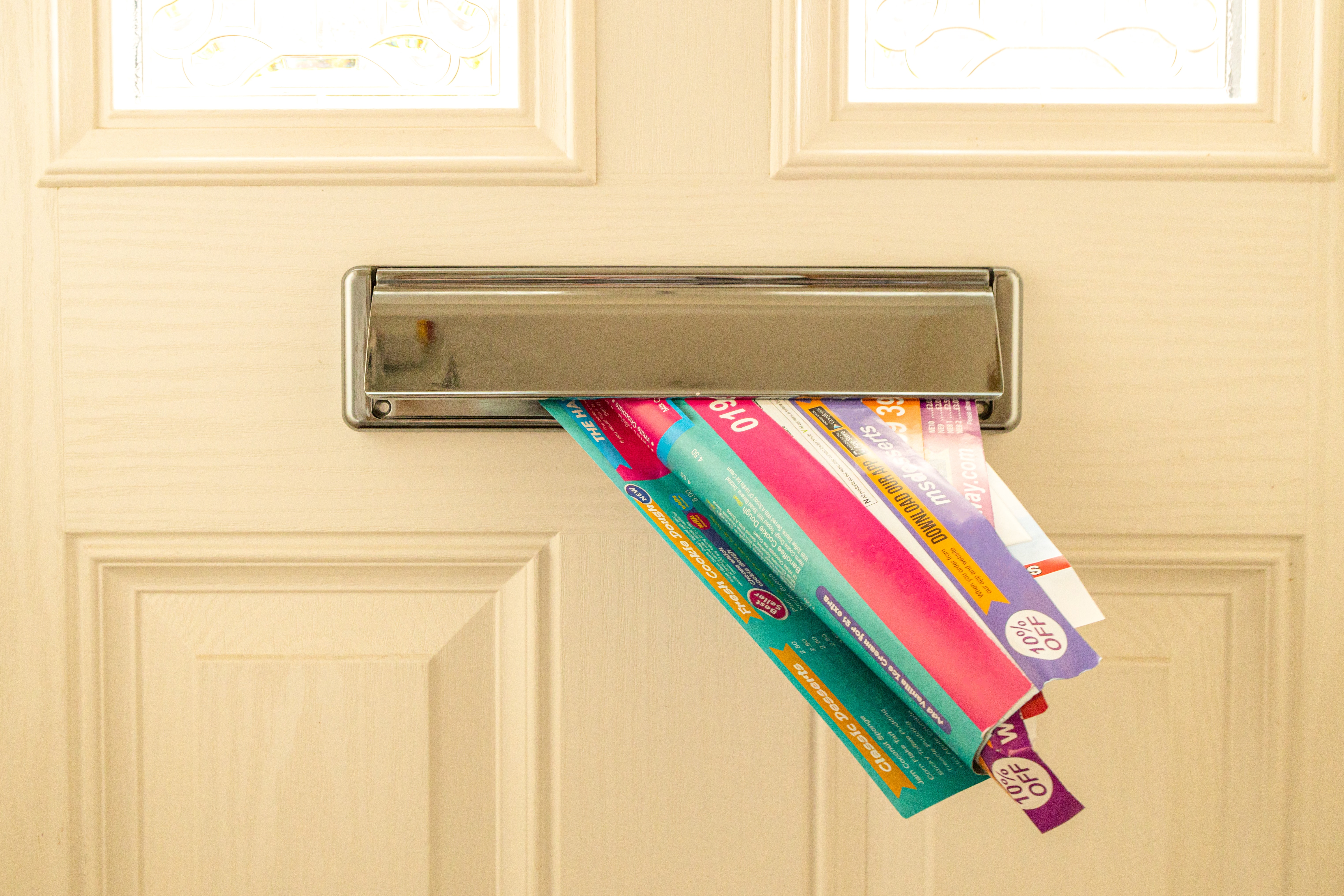 junk mail stuffed through a letter box